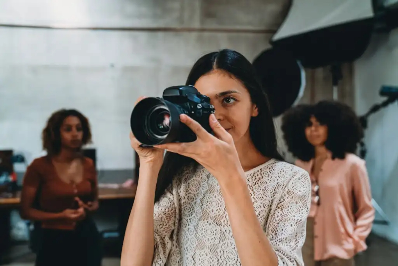 a woman shooting with a camera